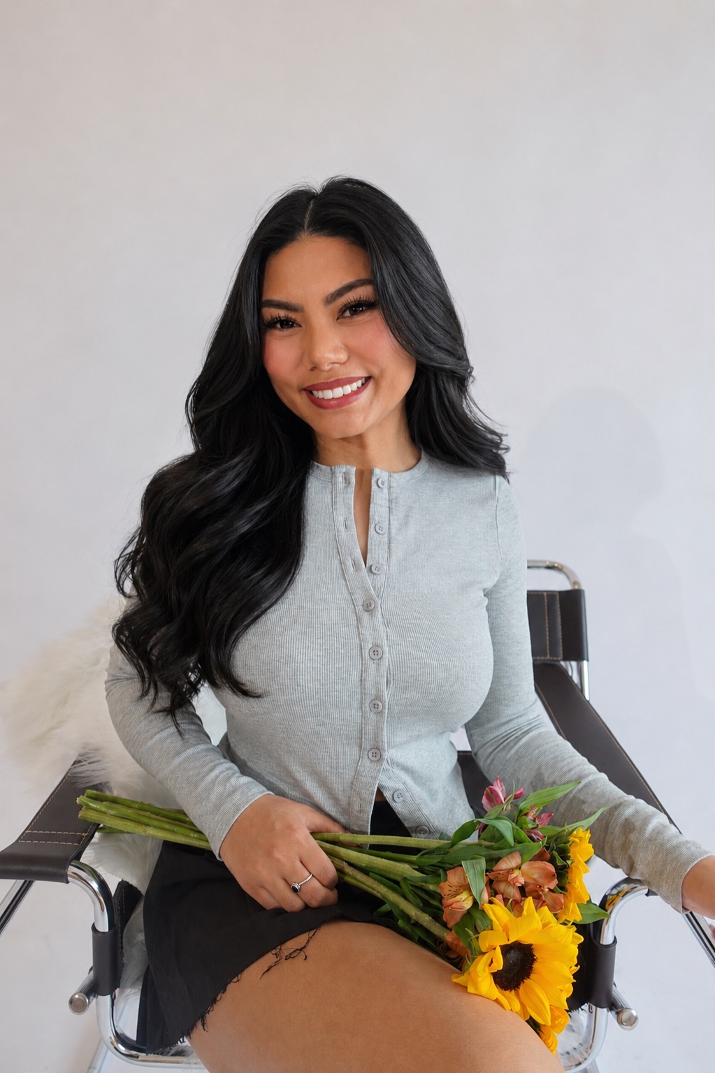Stephanie Nguyen seated with a bouquet of flowers